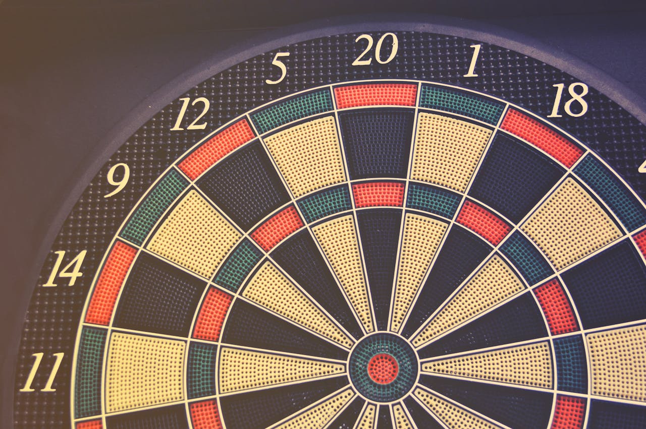 Close-up of a dartboard displaying numbers and colored segments, perfect for themes of accuracy and games.